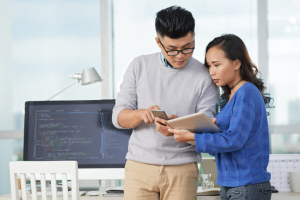 Business partners using their gadgets for work at office, Salesforce Certification Verification