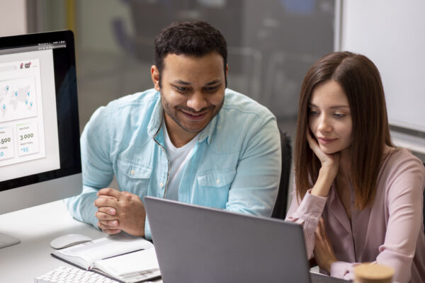 Two employees checking on the laptop, Salesforce Admin Course