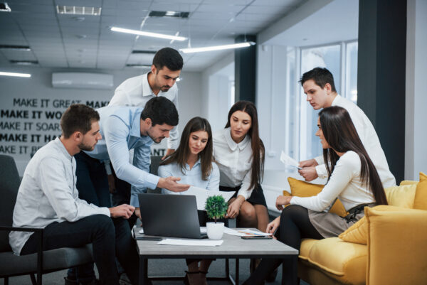 Young professionals having a team discussion in a modern office environment, exploring CRM solutions like Salesforce Starter in Pennsylvania.
